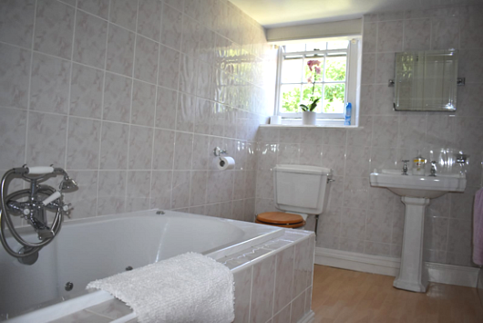 Large jacuzzi bath in family bathroom